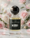 Perfume bottle labeled 'Rose Reverie SOBO' with pink roses in the background